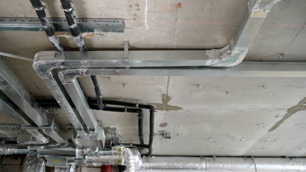 istock Ceiling in a new apartment with a system of ventilation pipes and wires. Ventilation system in a modern residential apartment during the construction phase, no people. 1403707621