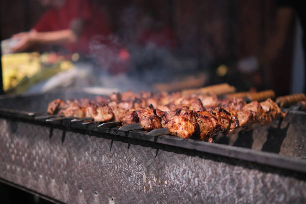 istock Roasting juicy meat steak with spices in burning charcoals fire on bbq grid 1403708944