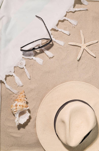 istock Beach Towel on sand beach with sun hat for summer vacation 1403709084