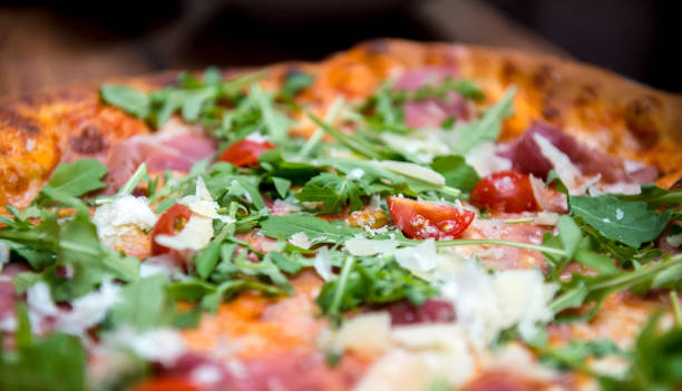 istock Pizza with dry cured ham and arugula close-up 1403709247