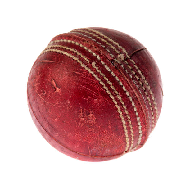 istock Old red leather cricket ball isolated against a white background 1403712550