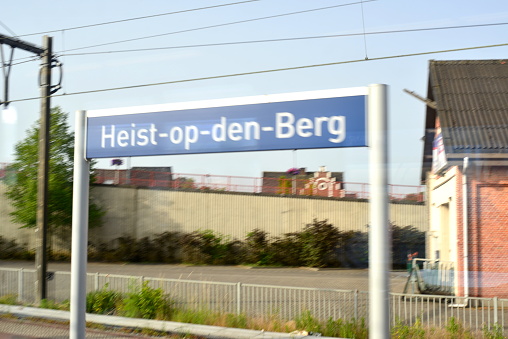 Heist-Op-Den-Berg, Vlaams-Brabant, Belgium - June 18, 2022: Motion blur from photographing from inside a passenger train leaving the departure platform railway station