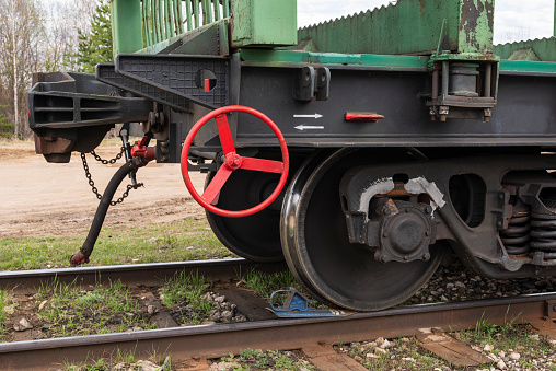 Red brake wheel on a railway train carriage. Train on the railway on the brake pad.