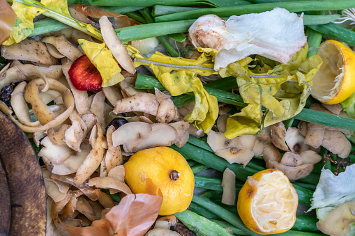 natural fertilizers, Composting pile of rotting kitchen leftover fruits and vegetable scraps background or surface. Fruit and vegetable peels and residues collected to make Composting fertilizers