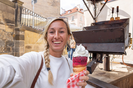 Solo travel woman exploring the city and the famous landmarks eating local street food.
Prague, Czech Republic