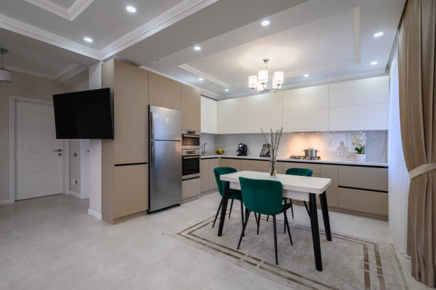 istock Modern white and beige large luxurious kitchen and dining table in studio apartment 1403726810