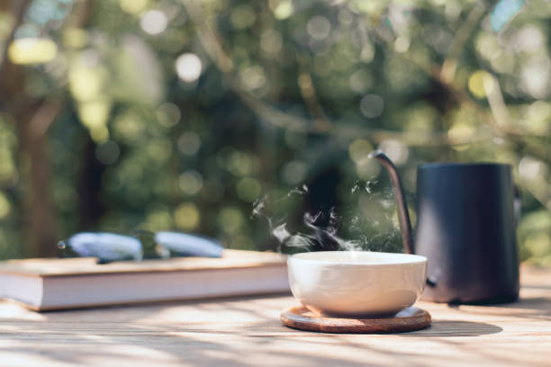 istock Garden reading table, Teacup placed on wooden table, Close-up 1403736293