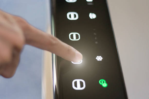 istock Air conditioning technology, Finger pressing the cooling button, Close-up. 1403737106