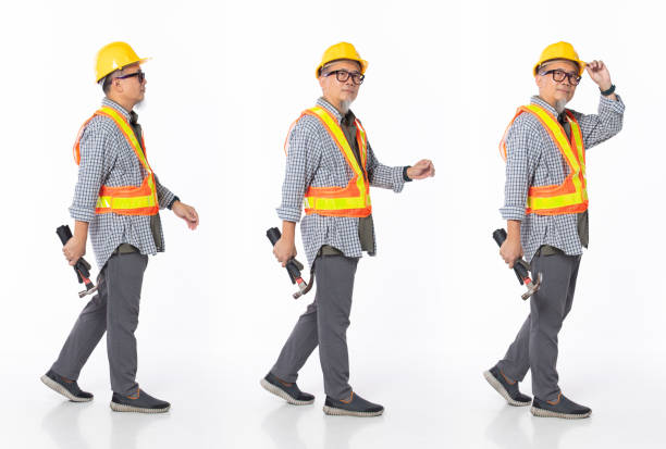 istock Full length 50s 60s Asian Chinese contractor builder engineer man, walking forward left right 1403748398