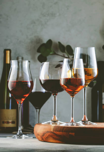 istock Wine glasses ans bottles assortment. Red, white, rose wines on gray table background. Wine bar, shop, tasting concept 1403749078
