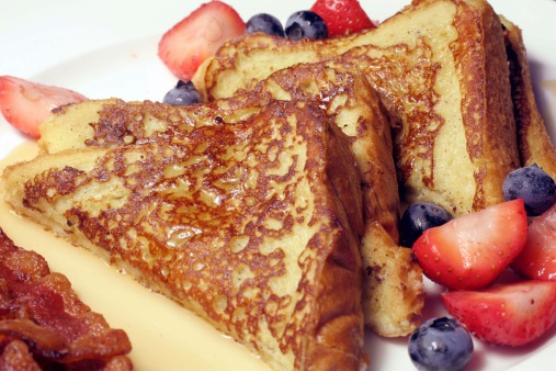 This is an image of french toast and berries.