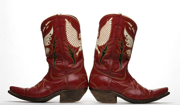 1950's Western Boots With Eagle and Butterfly A vintage pair of red western boots with the butterfly motif popular in the United States West in the 1950's. boot photos stock pictures, royalty-free photos & images
