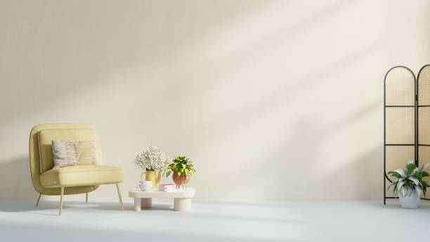 istock Interior has a yellow armchair on empty cream color wall background. 1403750206