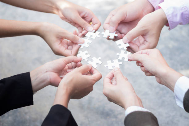 istock business teamwork concept holding puzzle pieces 1403752846