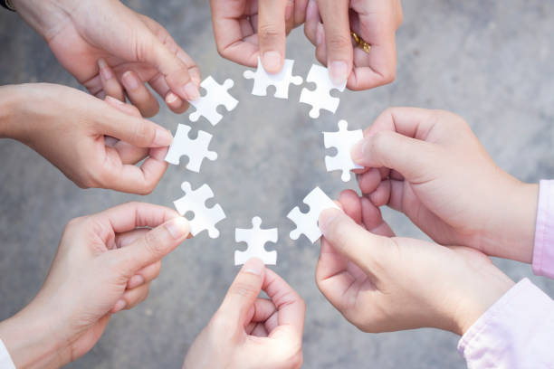 istock teamwork of business people assembling jigsaw puzzle 1403752872