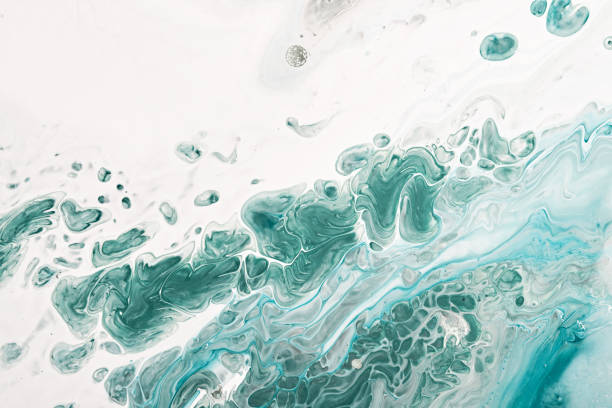 istock Fluid Art acrylic paints. Abstract mixing blue and green waves on white background. Liquid flows splashes. Marble effect background or texture 1403753839