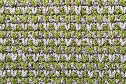 Gray green knitting wool texture background. Canvas is crocheted of natural threads in natural colors.