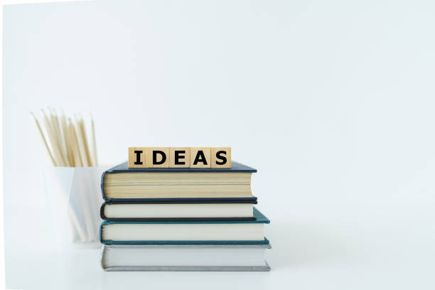 istock Book or textbook stack and pencil with word IDEAS. Skill improvement for student or businessperson. Studying and training course online at home. Business success idea, education learning concept 1403757310
