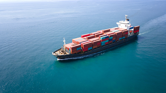 Aerial top view Container ships transporting large cargo and tugboat to import and export