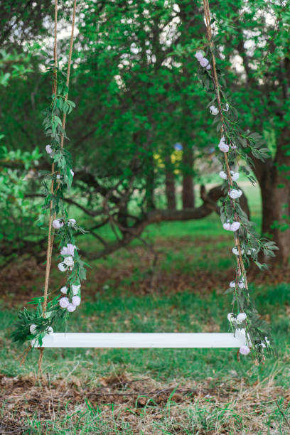 istock An empty wooden swing on ropes in an apple orchard. 1403760588