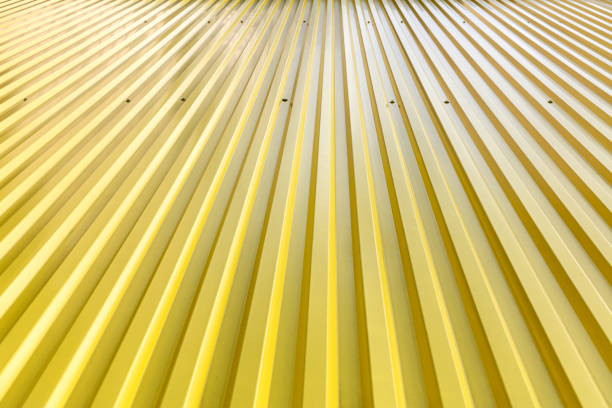 yellow corrugated metal roof texture under sunlight with bright reflections
