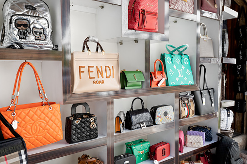 16 May 2022, Antalya, Turkiye: Counterfeit fakes of bags of famous world brands of fashion accessories for sale at market - Gucci, Yves Saint Laurent, Chanel and others