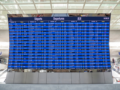Paris, France. Monitors with departures and arrivals flights at Charles de Gaulle international airport