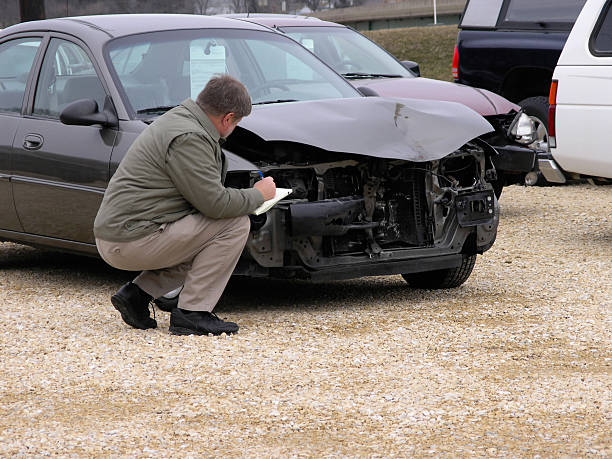 istock Insurance claim adjuster inspects front of vehicle 140376685