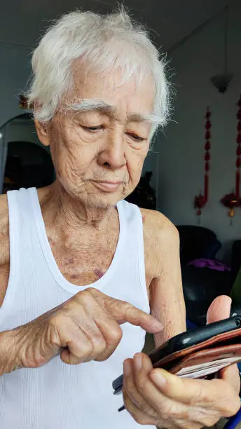 Portrait of an elderly man using smartphone at home. A never too old to learn attitude.