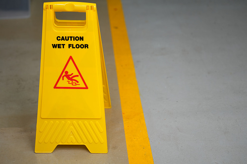 Warning sign for wet floor in the factory office