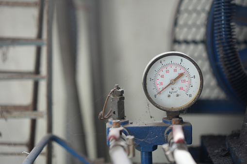 close up of pressure gauge on old machine background, engineering equipment concept