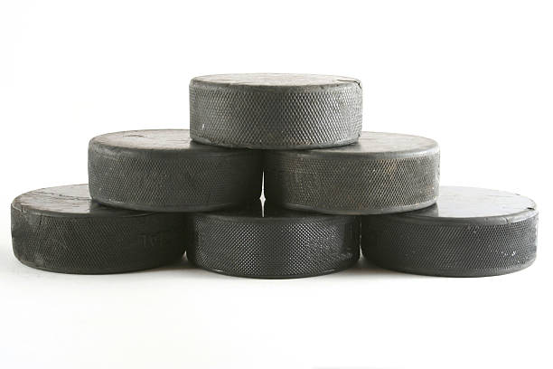 pile of hockey pucks stock photo