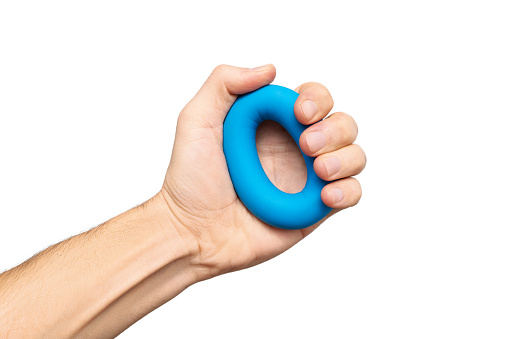 Isolated blue hand gripper or espander for exercising in fitness and strength