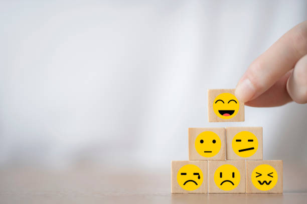 Hand Changing with smile emoticon icons  face on Wooden Cube , Costumer service concept stock photo