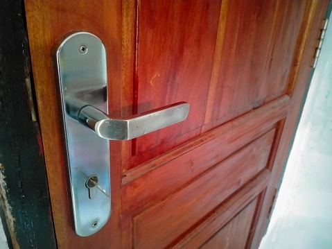 door handle on natural wooden door