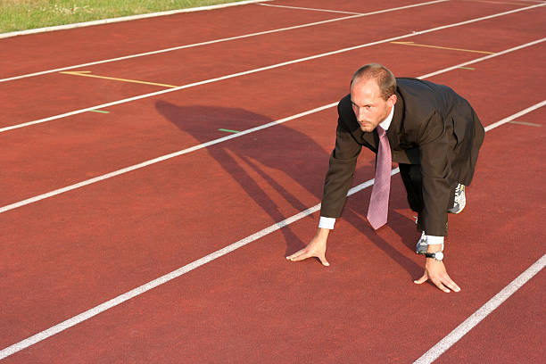 istock Business man on a running track ready to run 140377510