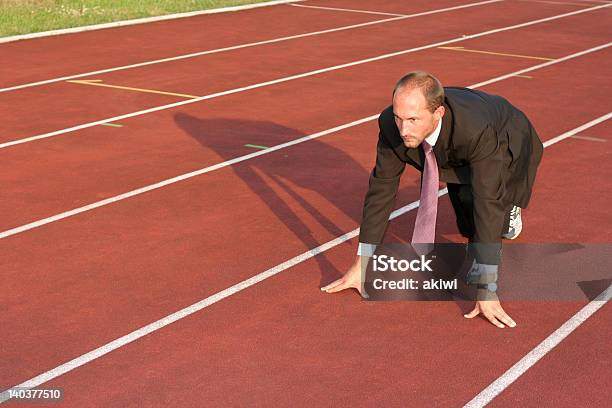 Business Man On A Running Track Ready To Run Stock Photo - Download Image Now - Activity, Adult, Adults Only