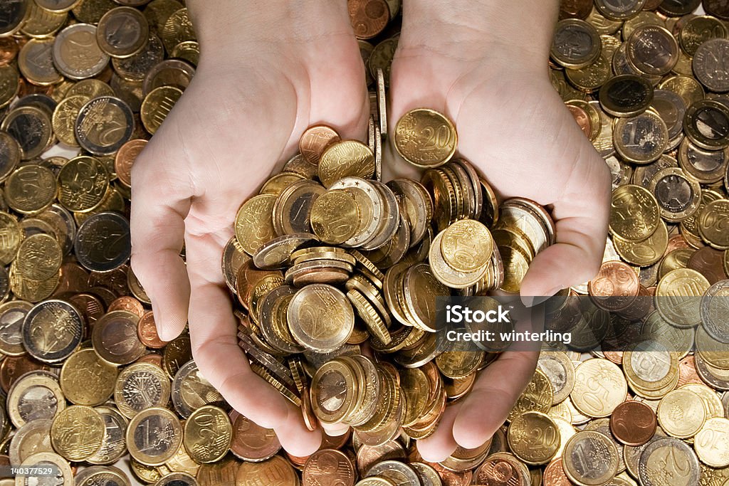 Fistful of Money Female hands grabbing shiny coins. Collection Stock Photo