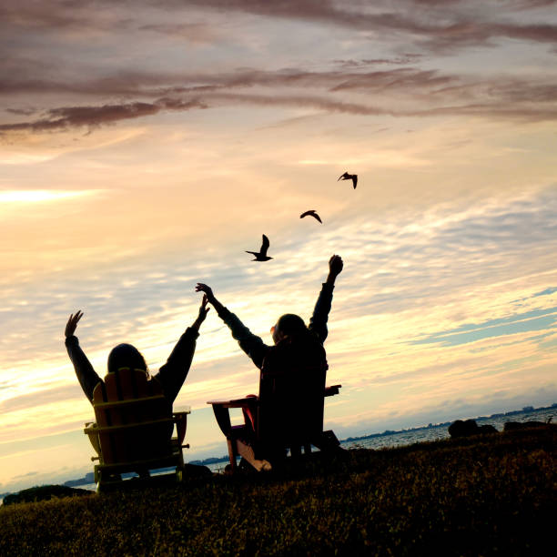 Free Stock Photo of Silhouettes sitting by the sea at sunset | Download ...