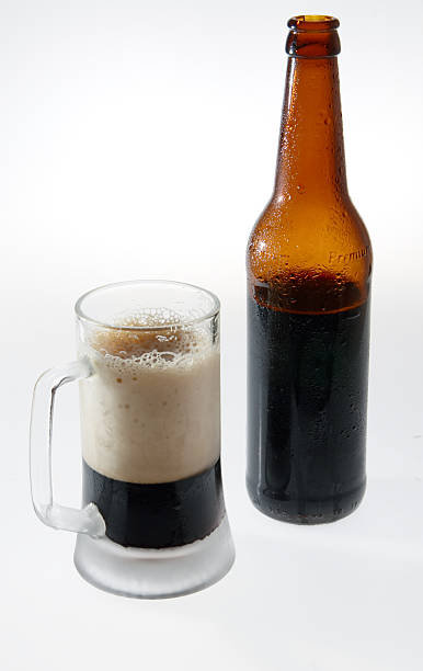 Dark beer (1). The open bottle of porter and mug with a dark beer. froth beer bubble quencher stock pictures, royalty-free photos & images