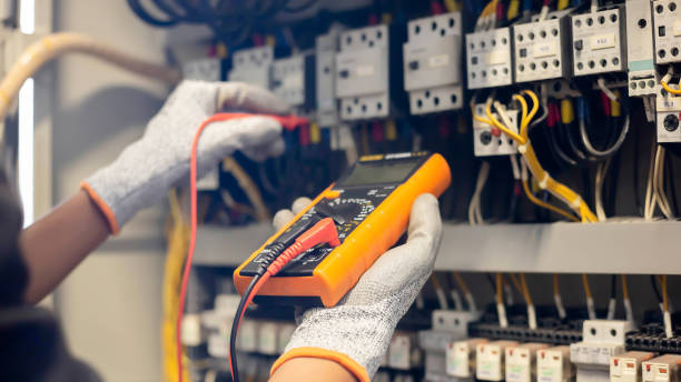 istock Electrician engineer uses a multimeter to test the electrical installation and power line current in an electrical system control cabinet. 1403779834