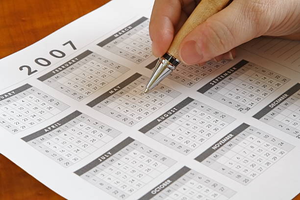 istock Hand holding a pen to calendar 140378440