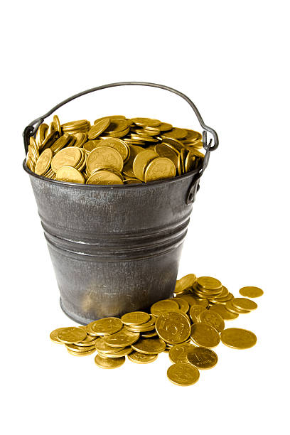 Full bucket of golden coins stock photo