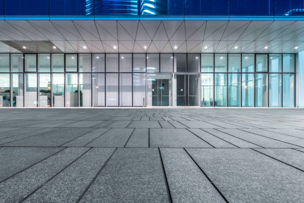 glass office wall and Empty pavement at night stock photo