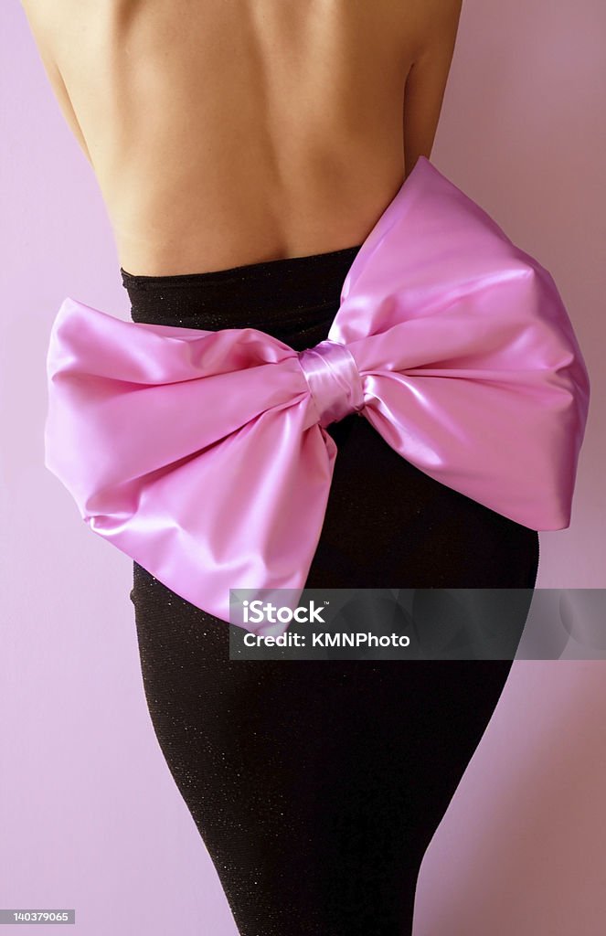 Beautiful party dress Back view of black party dress with big pink satin bow Adult Stock Photo