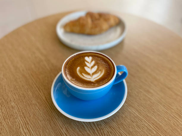 istock Hot coffee cup and croissant on table 1403790706