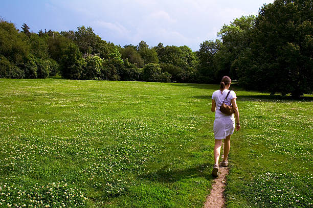 istock girl walking through meadow 140379189