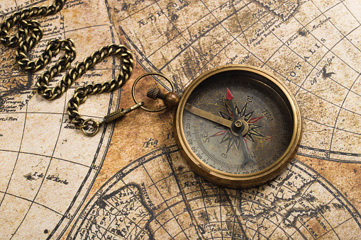 Old compass on vintage map. Adventure retro style
