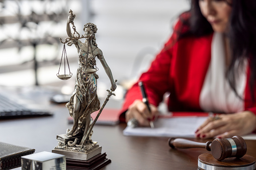 Legal and law concept. Statue of Lady Justice with scales of justice and wooden judge gavel on wooden table. Panoramic image statue of lady justice.