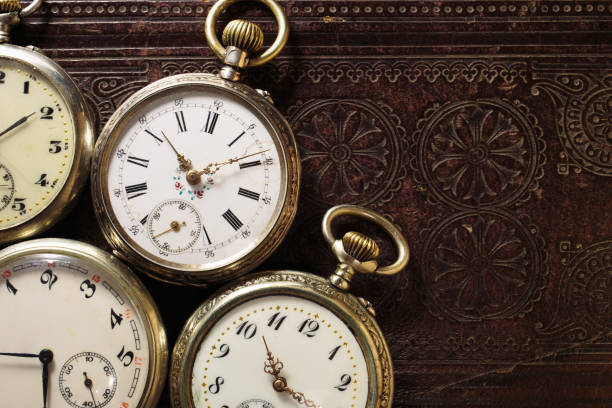 istock Set of old antique clocks on leather book background 1403793643